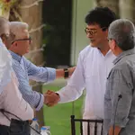 El portavoz del Gobierno colombiano Iván Danilo Rueda (c) conversa con los representantes del ELN Aureliano Carbonell (i) y Pablo Beltrán (d) durante una reunión en Caracas