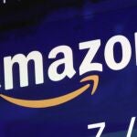 FILE - A logo for Amazon is displayed on a screen at the Nasdaq MarketSite, July 27, 2018. A fire broke out late Wednesday, Oct. 5, 2022, evening at an Amazon facility in upstate New York thatâ€™s voting in a union election next week. In a statement, an Amazon spokesperson called the incident a â€œsmall fire,â€ and said it was â€œcontained to a compactor thatâ€™s located just outside the doors of a loading dock.â€ (AP Photo/Richard Drew, File)