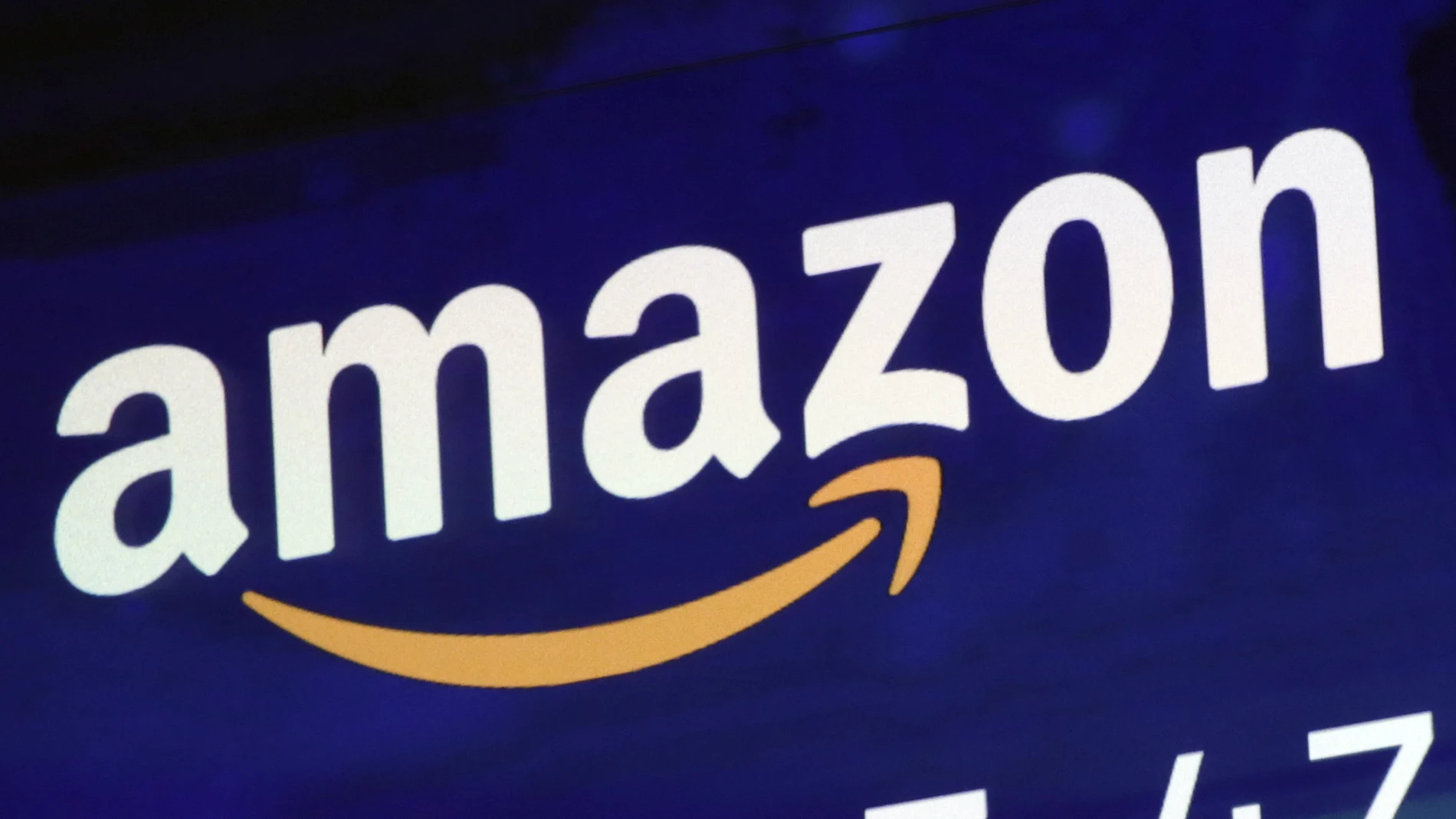 FILE - A logo for Amazon is displayed on a screen at the Nasdaq MarketSite, July 27, 2018. A fire broke out late Wednesday, Oct. 5, 2022, evening at an Amazon facility in upstate New York that’s voting in a union election next week. In a statement, an Amazon spokesperson called the incident a “small fire,†and said it was “contained to a compactor that’s located just outside the doors of a loading dock.†(AP Photo/Richard Drew, File)