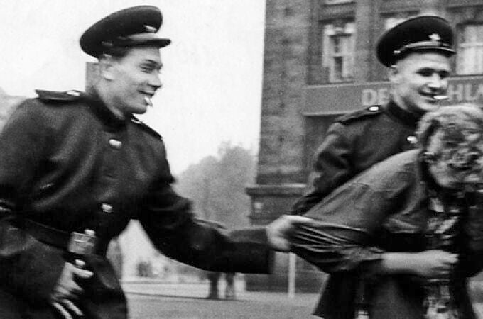 Dos soldados rusos acosan a una mujer alemana después de tomar Berlín