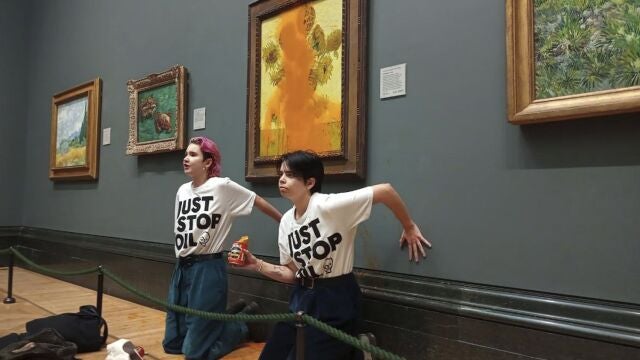 Las activistas con las manos pegadas a la pared bajo el cuadro de van Gogh manchado con sopa de tomate
