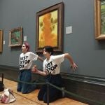 Las activistas con las manos pegadas a la pared bajo el cuadro de van Gogh manchado con sopa de tomate