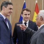 El jefe del Gobierno español, Pedro Sánchez (i), y el primer ministro portugués, António Costa (d), conversan con el presidente galo, Emmanuel Macron (c), al inicio del encuentro tripartito