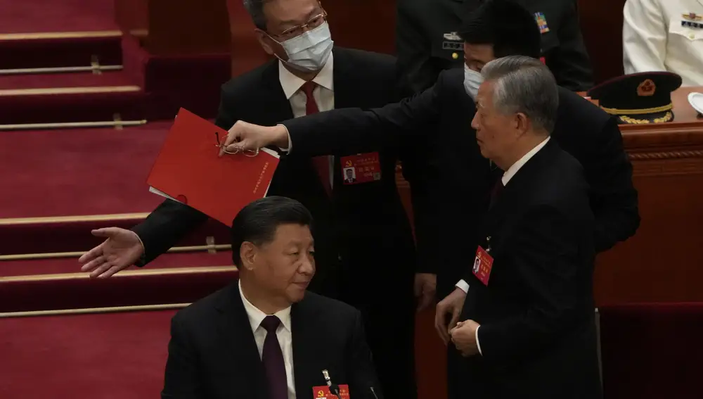 El presidente chino Xi Jinping, a la izquierda, observa cómo el ex presidente chino Hu Jintao es ayudado a abandonar la sala durante la ceremonia de clausura del 20º Congreso Nacional del gobernante Partido Comunista de China en el Gran Salón del Pueblo en Pekín