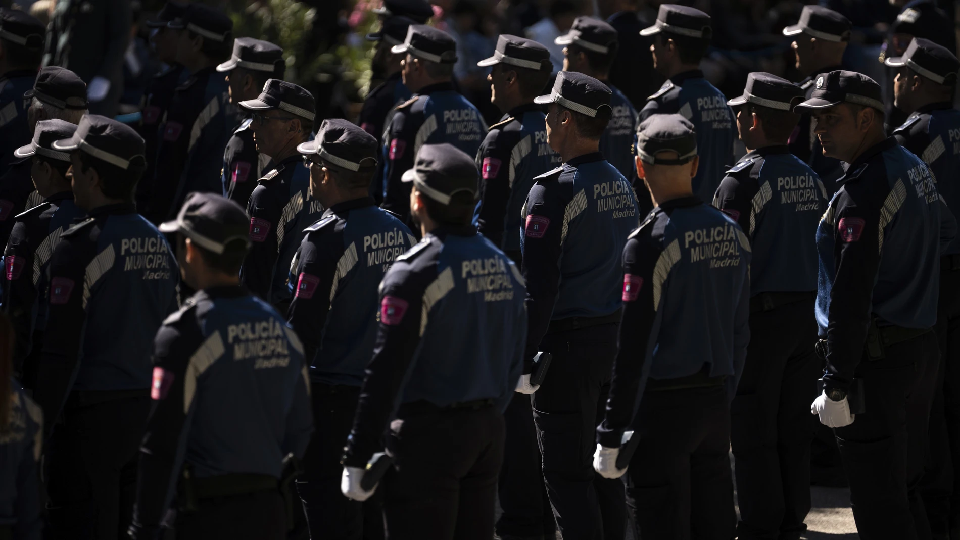 Agentes de la Policia Municipal durante el acto de conmemoracion de la festividad de San Juan Bautista, patron de la Policia Municipal, en el parque de El Retiro