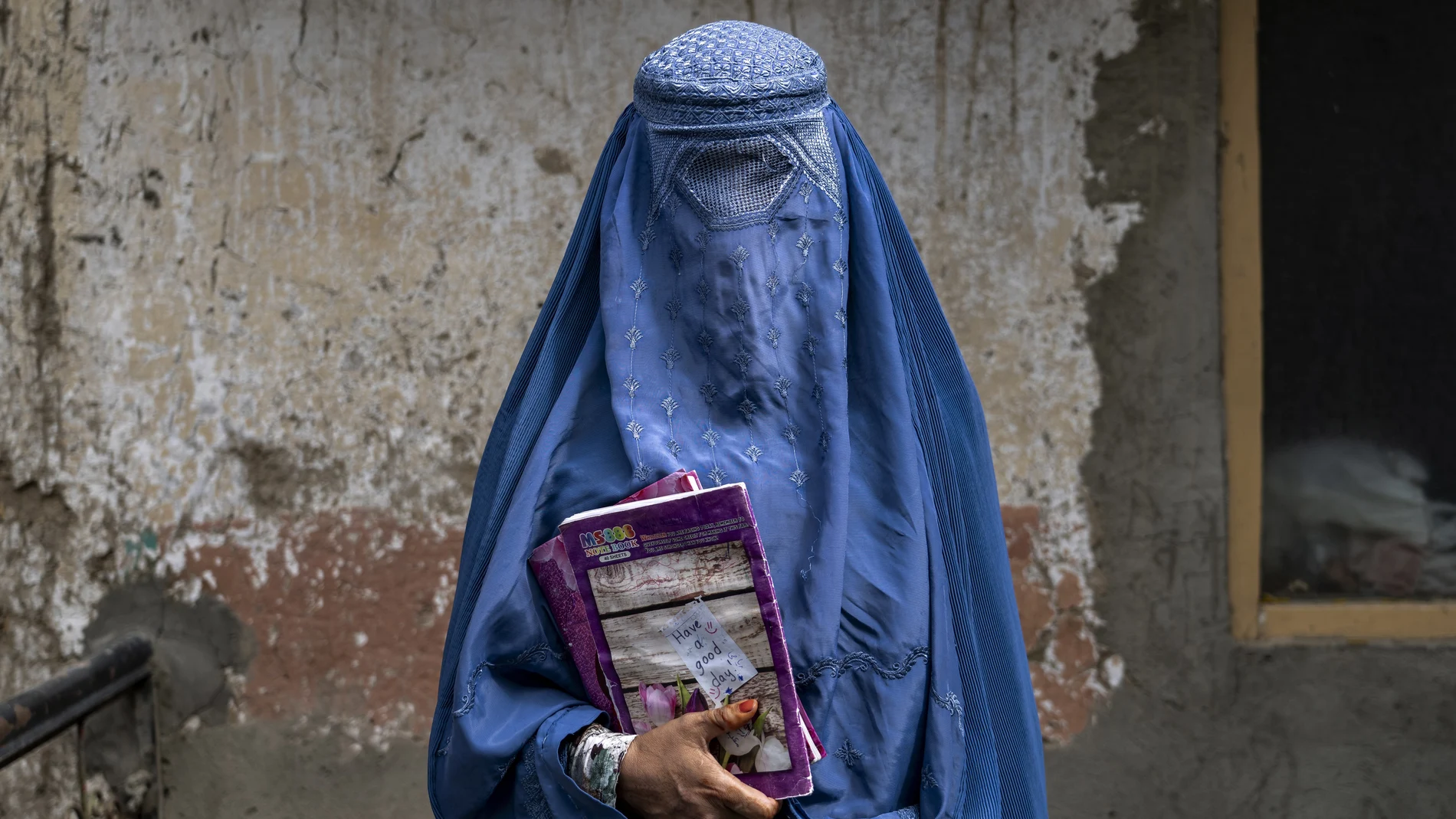 Arefeh, una mujer afgana de 40 años, sale de una escuela clandestina, en Kabul, Afganistán