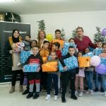 El presidente de la Fundación Cajasol, Antonio Pulido, entrega juguetes a los niños de la ONG Cooperación Internacional en el marco de la campaña 'Un juguete, una ilusión'