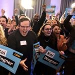 Supporters of the Christian Democratic Union party (CDU) cheer after the announcement of the first forecast after the state elections in Berlin, Germany, Sunday, Feb. 12, 2023. The city of Berlin on Sunday, Feb. 12, 2023, holds a court-ordered rerun of a chaotic 2021 state election that was marred by severe glitches at many polling stations. (Fabian Sommer/dpa via AP)