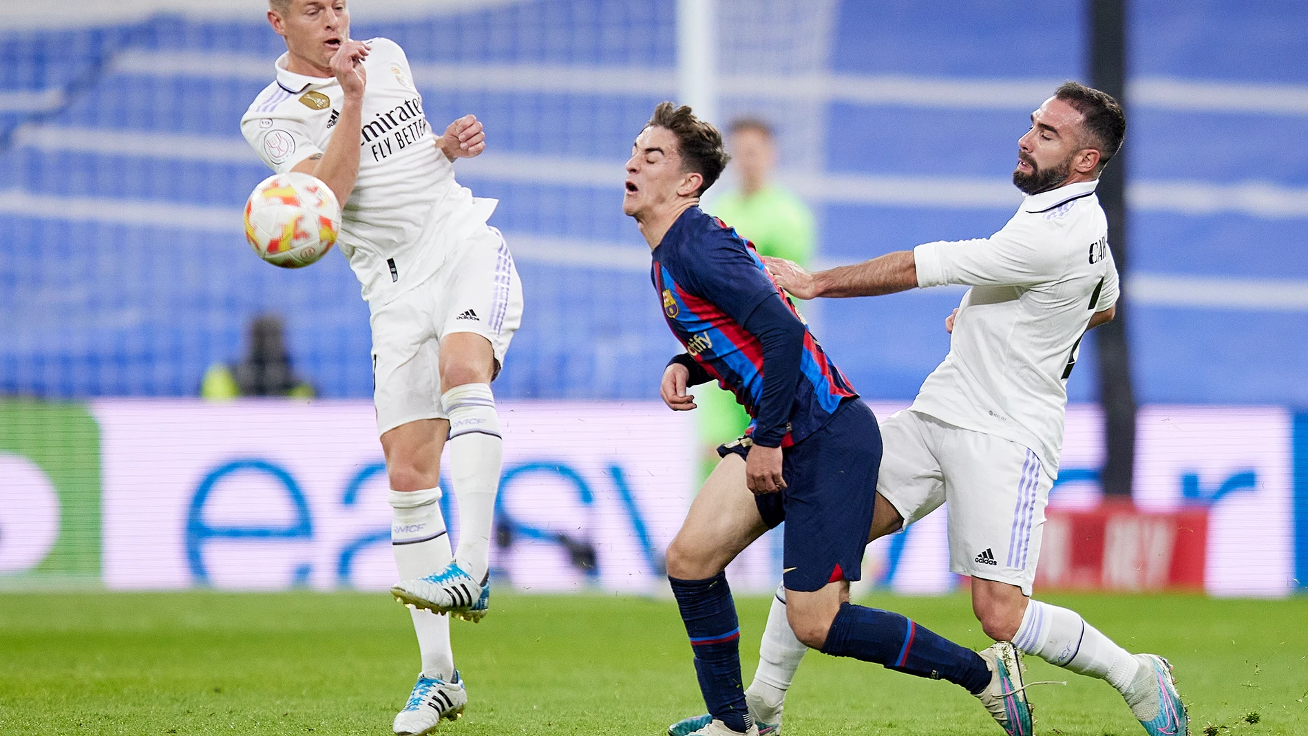 02 March 2023, Spain, Madrid: Barcelona's Gavi in action with Real Madrid's Daniel Carvajal and Toni Kroos during the Spanish Copa del Rey (King's Cup) semifinal match between Real Madrid and Barcelona at the Santiago Bernabeu Stadium. Photo: Ruben Albarran/ZUMA Press Wire/dpaRuben Albarran/ZUMA Press Wire/d / DPA02/03/2023 ONLY FOR USE IN SPAIN
