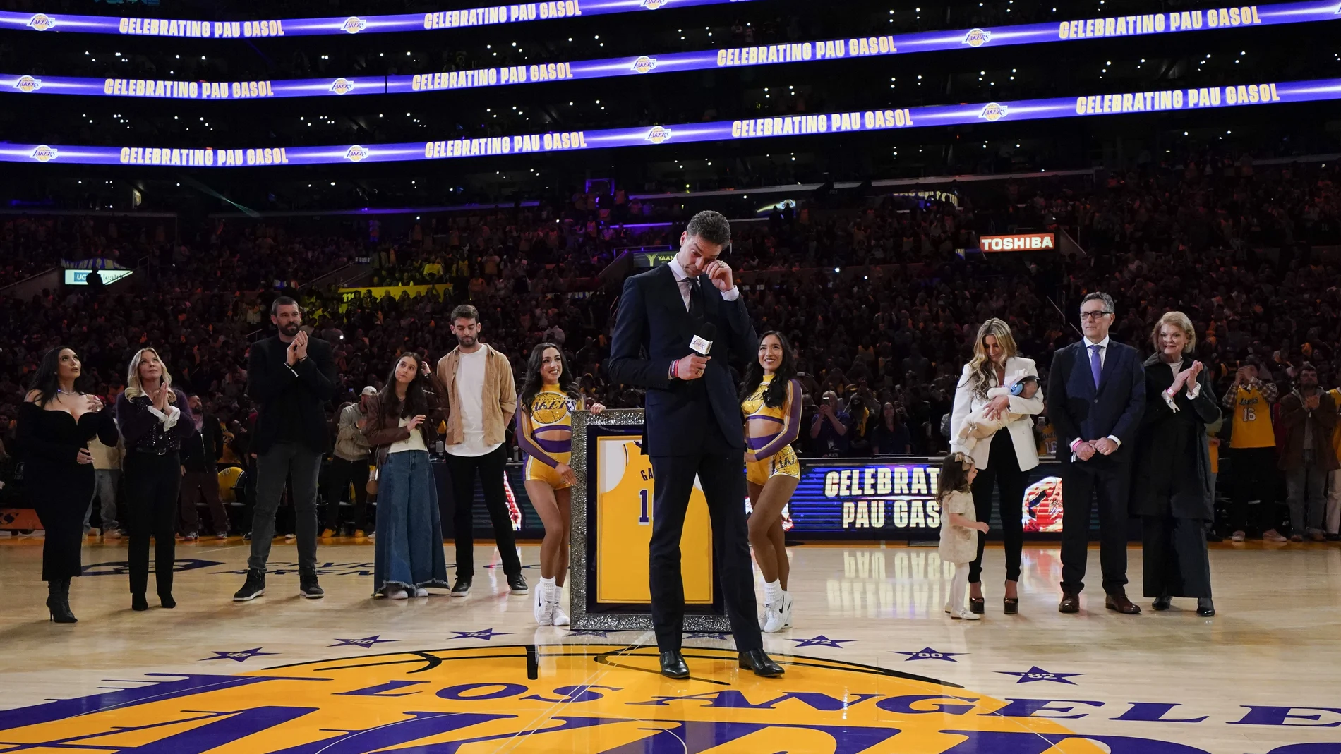 Former Los Angeles Lakers forward Pau Gasol wipes his tears while speaking at his jersey retirement ceremony during halftime of the team's NBA basketball game against the Memphis Grizzlies