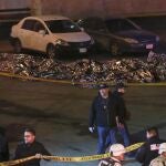 The bodies of migrants lay covered after a deadly fire broke out at an immigration detention center in Ciudad Juarez, Mexico, Tuesday, March 28, 2023.