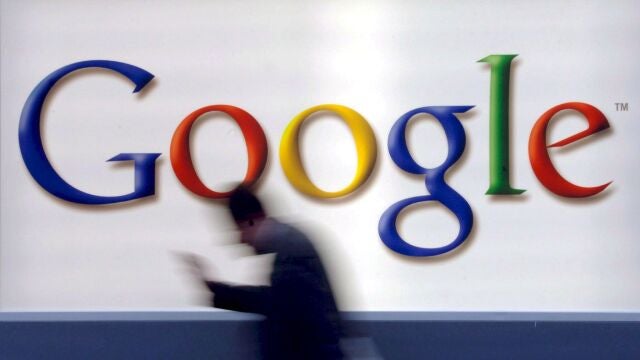 A man passes by a Google logo in Frankfurt, Germany,