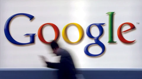 A man passes by a Google logo in Frankfurt, Germany,