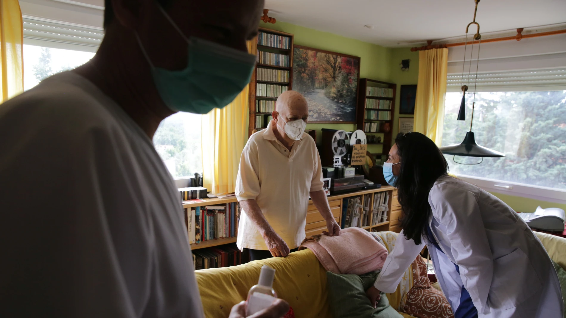 Una médica de familia atiende a un paciente en su domicilio en Madrid