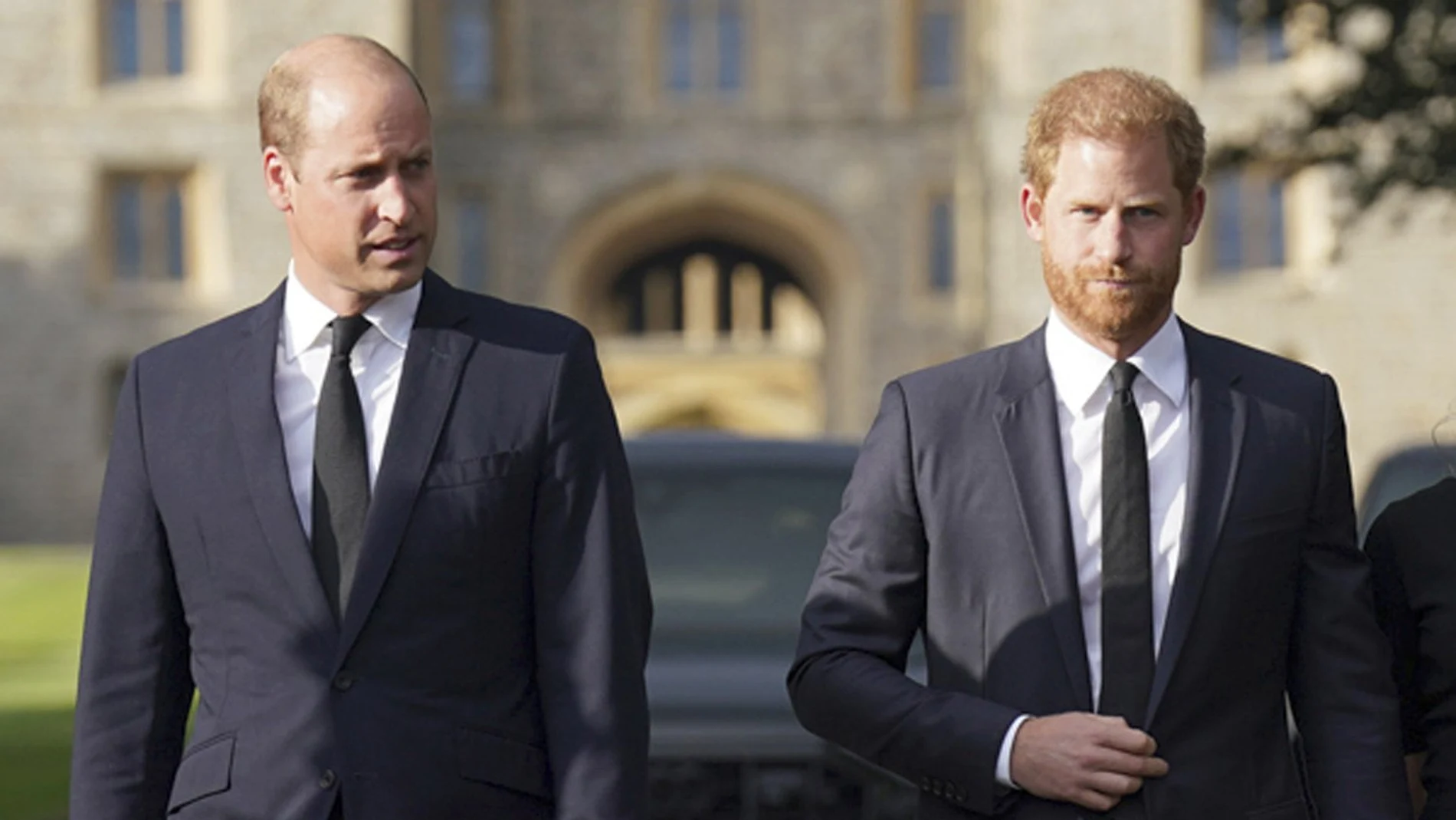 Britain's Prince William, Prince of Wales, left and Prince Harry walk to meet members of the public at Windsor Castle, following the death of Queen Elizabeth II 