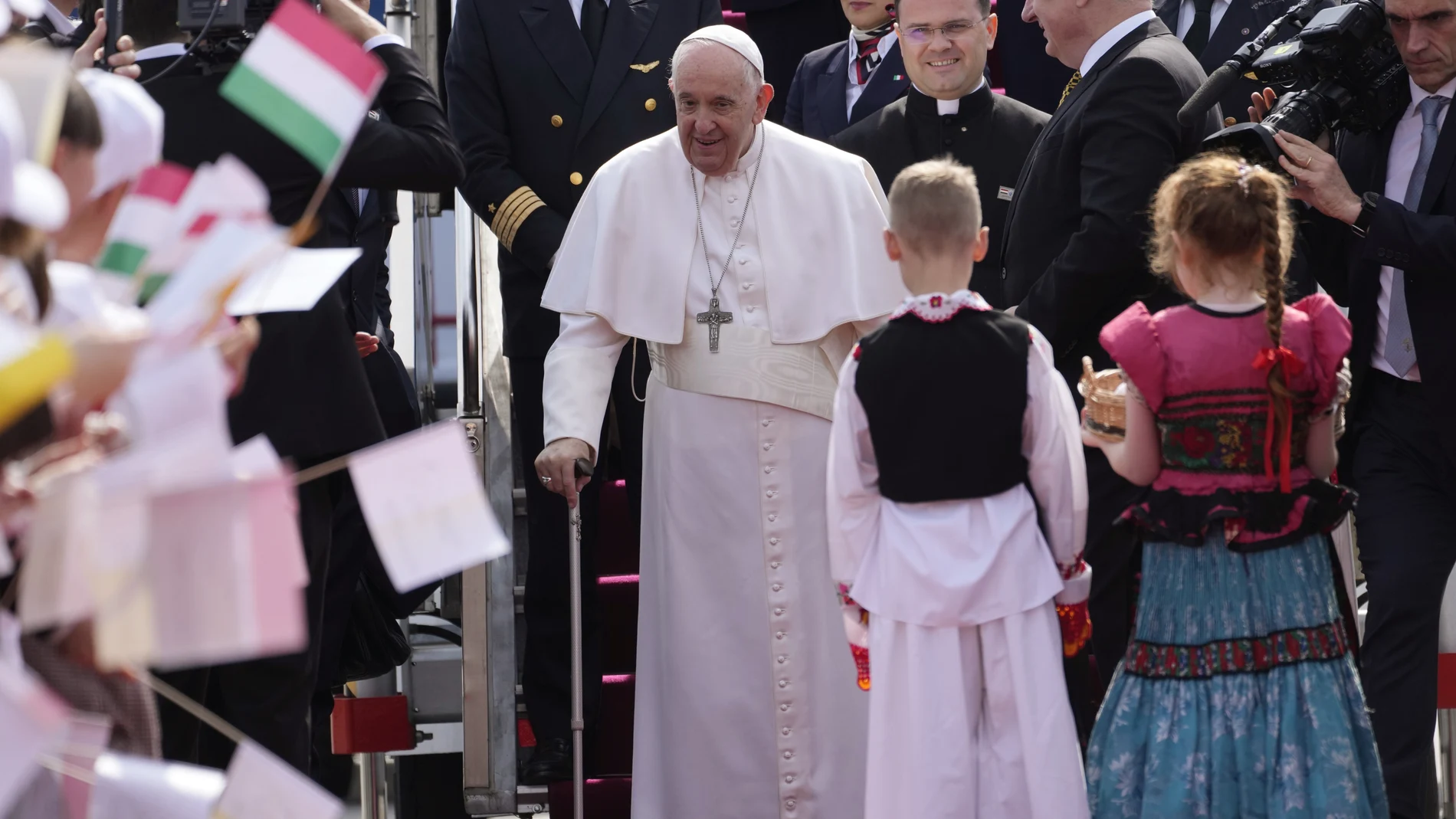 Pope Francis smiles as he arrives for the official welcome ceremony at Budapest's International Airport in Budapest, Hungary, Friday, April 28, 2023.