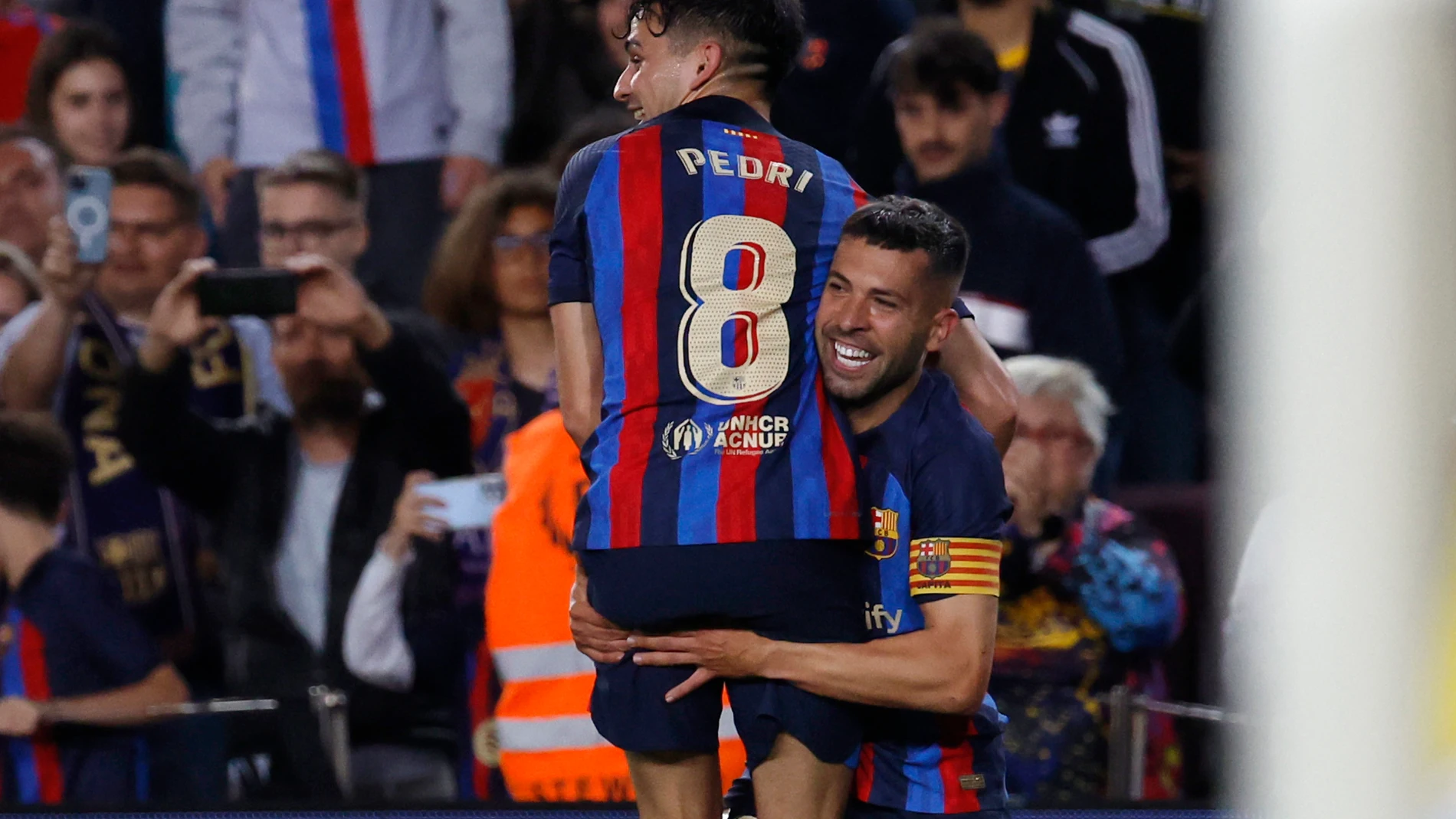 Barcelona's Jordi Alba, right, celebrates after scoring his side's opening goal during a Spanish La Liga soccer match between Barcelona and Osasuna at the Camp Nou stadium in Barcelona, Spain, Tuesday, May 2, 2023. (AP Photo/Joan Monfort)