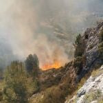 Castellón.- Medios terrestres y aéreos trabajan en la extinción de un incendio forestal en Viver