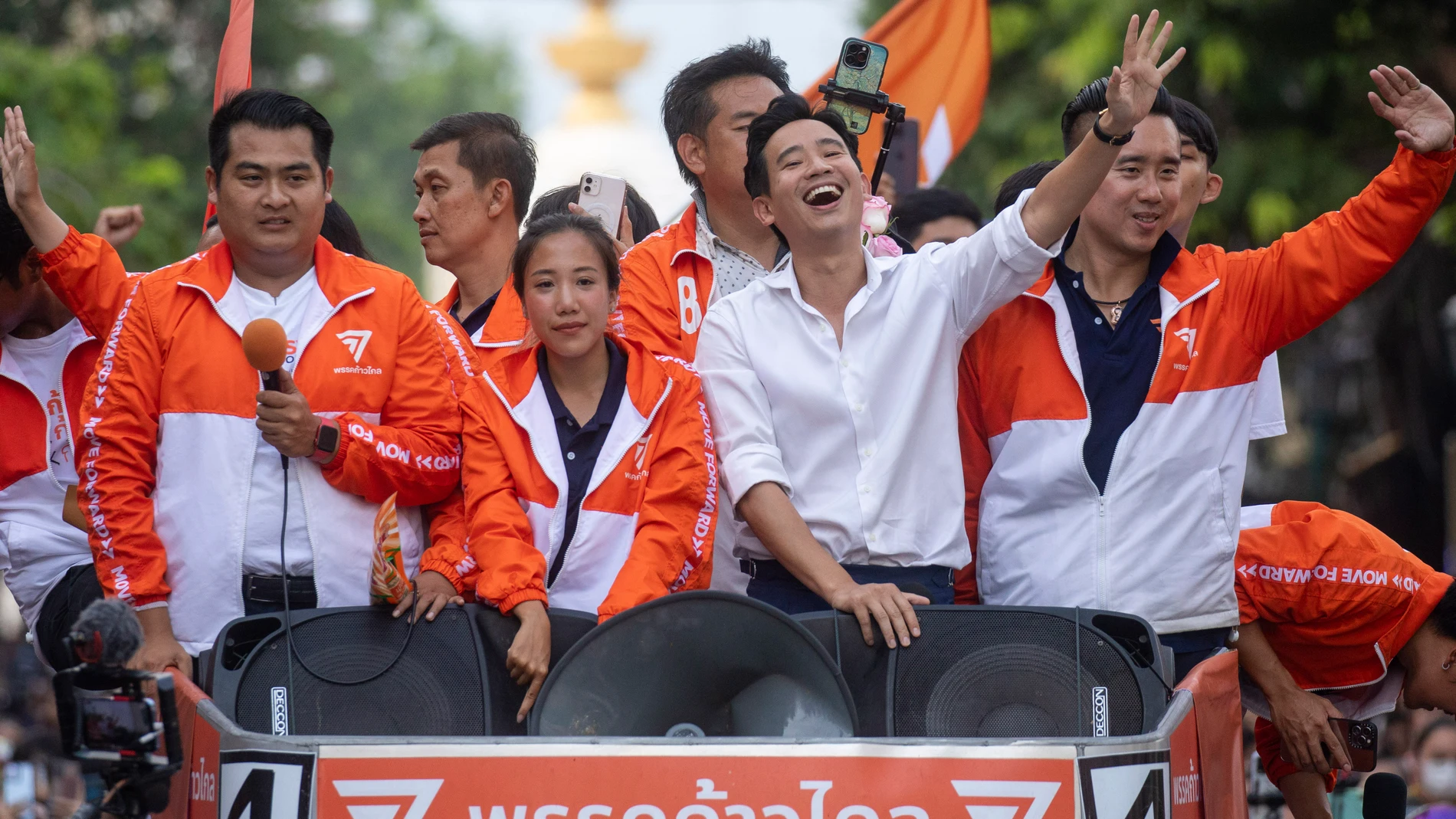 Pita Limjaroenrat, center, (white shirt) leader of Move Forward Party, waves to his supporters, in Bangkok, Monday, May 15, 2023. Fresh off a stunning election victory in which they together captured a majority of seats in the House of Representatives, Thailand's top two opposition parties began planning Monday for the next stage in their bid to replace the military-dominated government. (AP Photo/Wason Wanichakorn)