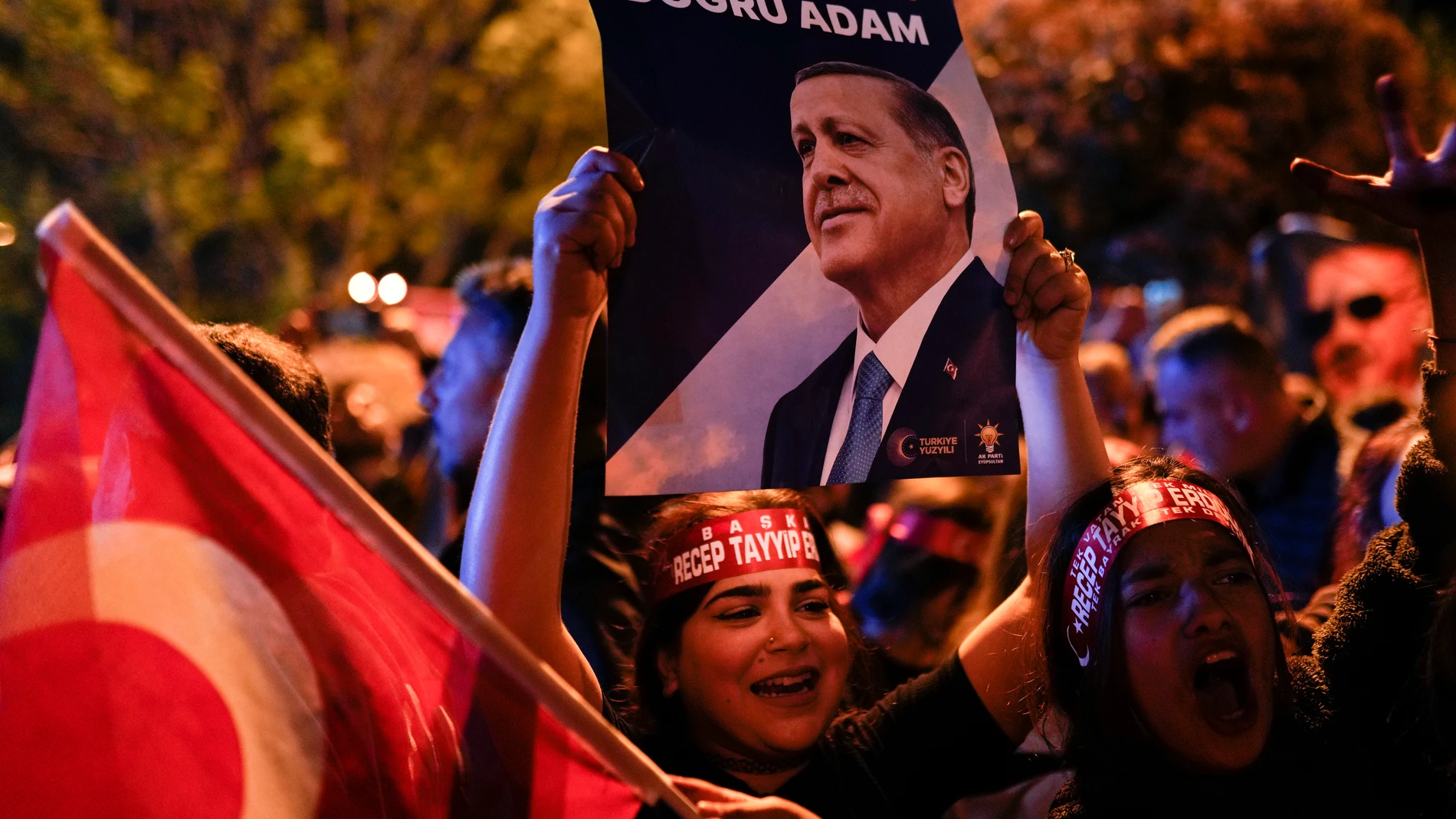 Supporters of Turkish President Recep Tayyip Erdogan cheer outside AKP (Justice and Development Party) headquarters in Istanbul, Turkey, Sunday, May 14, 2023. Turkish President Recep Tayyip Erdogan has remained in power for 20 years by repeatedly surmounting political crises: mass protests, corruption allegations, an attempted military coup and a huge influx of refugees fleeing Syria's civil war. Now the Turkish people and economy are being pummeled by sky-high inflation, and many are still recovering from a devastating earthquake in February made worse by the government's slow response. (AP Photo/Francisco Seco)