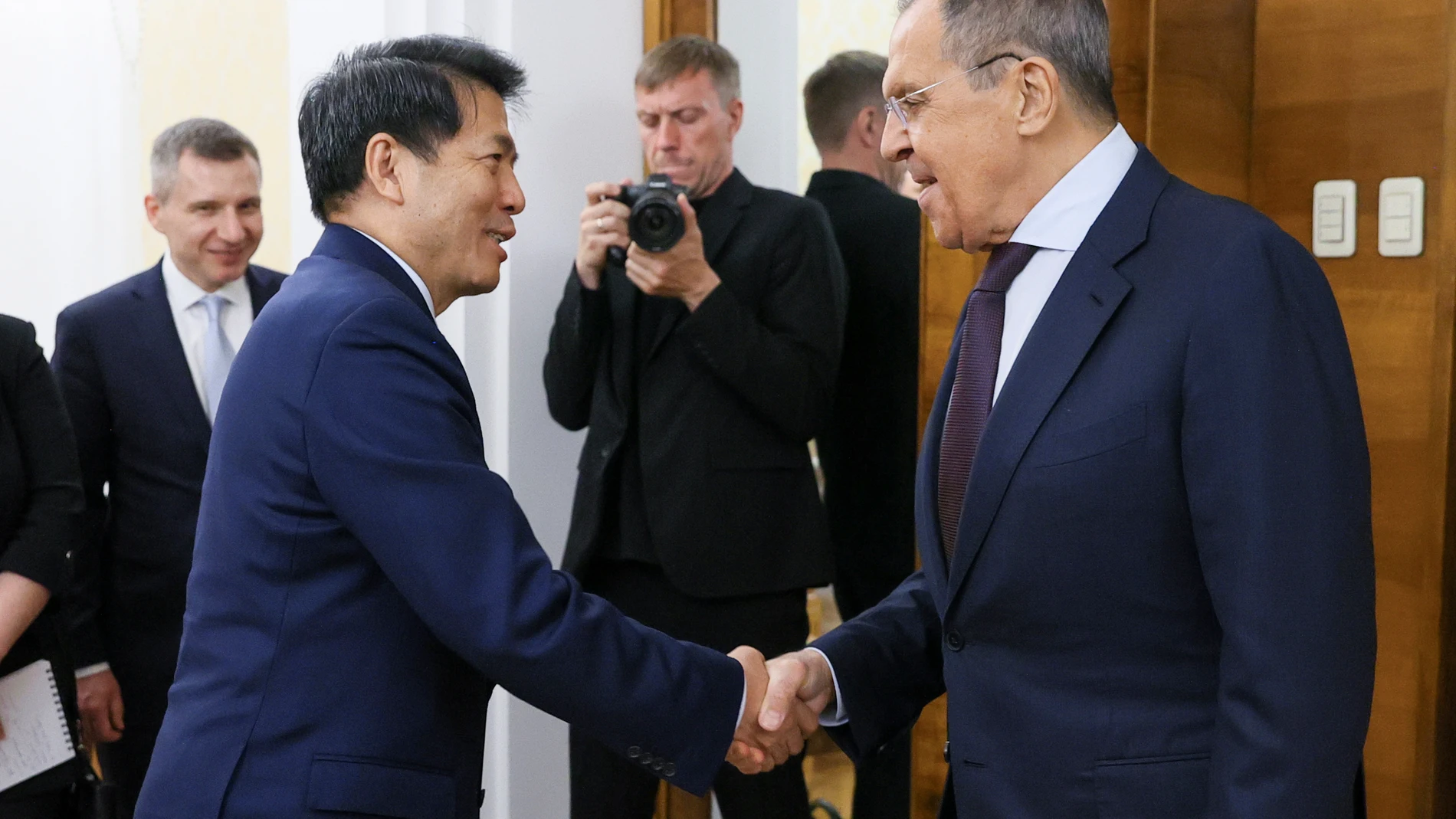 In this handout photo released by Russian Foreign Ministry Press Service, Russian Foreign Minister Sergey Lavrov, right, and Li Hui, China's special envoy for Eurasian affairs shake hands prior to their talks in Moscow, Russia, Friday, May 26, 2023. (Russian Foreign Ministry Press Service via AP)