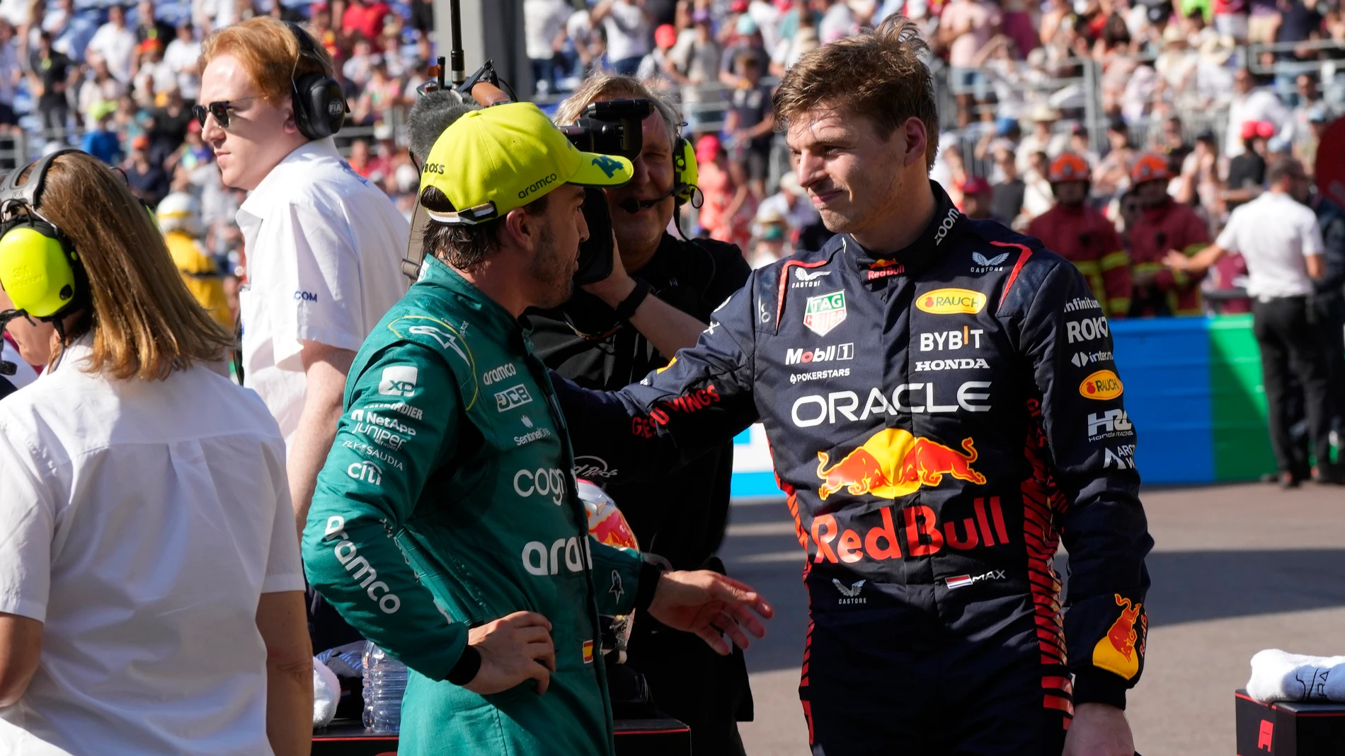 Aston Martin driver Fernando Alonso of Spain, left, speaks with Red Bull driver Max Verstappen of the Netherlands in the pit area at the end of the Formula One qualifying session at the Monaco racetrack, in Monaco, Saturday, May 27, 2023. The Formula One race will be held on Sunday with Verstappen taking pole position. (AP Photo/Luca Bruno)