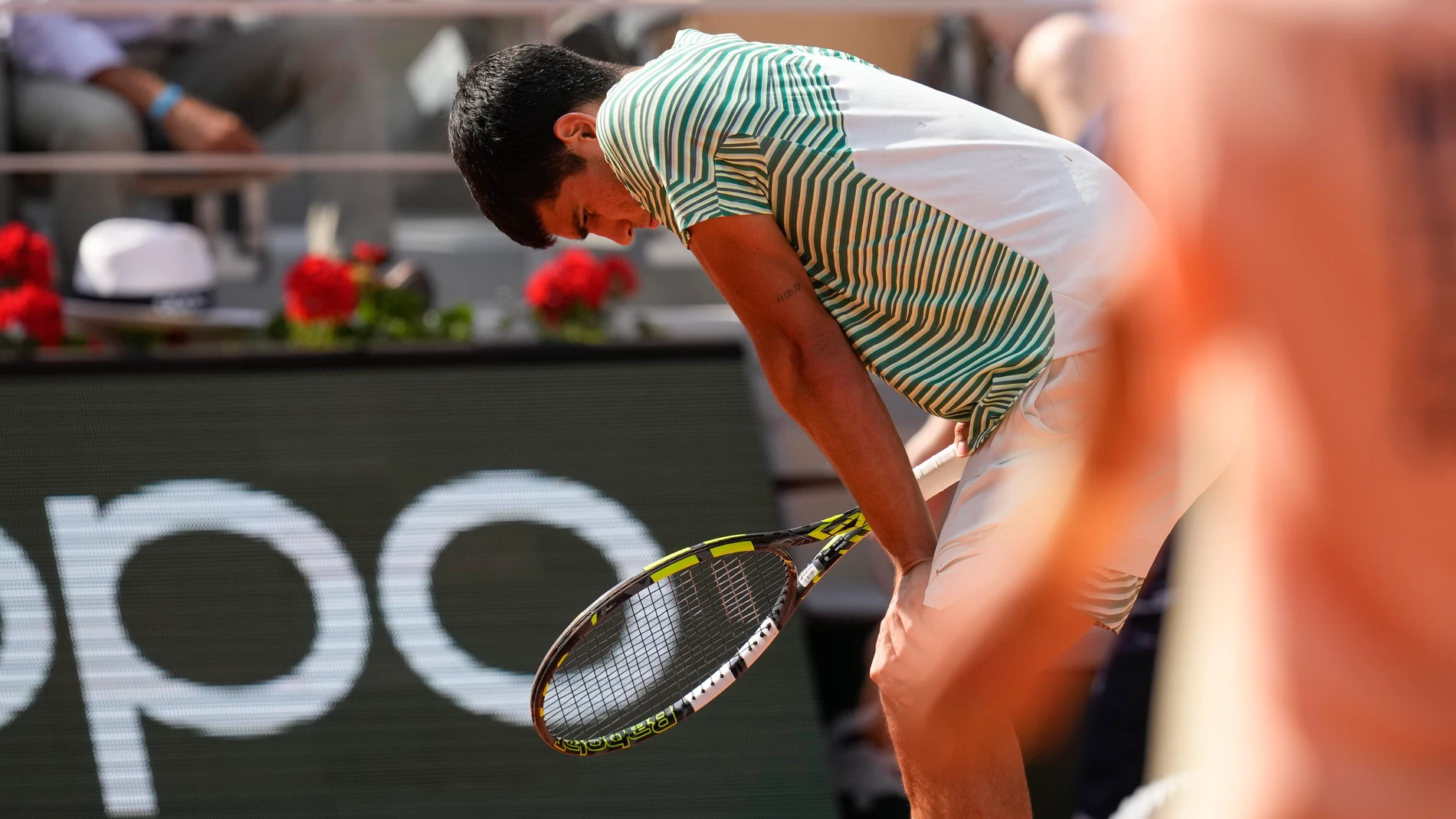 Spain's Carlos Alcaraz suffers form leg cramps during the semifinal match of the French Open tennis tournament against Serbia's Novak Djokovic at the Roland Garros stadium in Paris, Friday, June 9, 2023. (AP Photo/Christophe Ena)