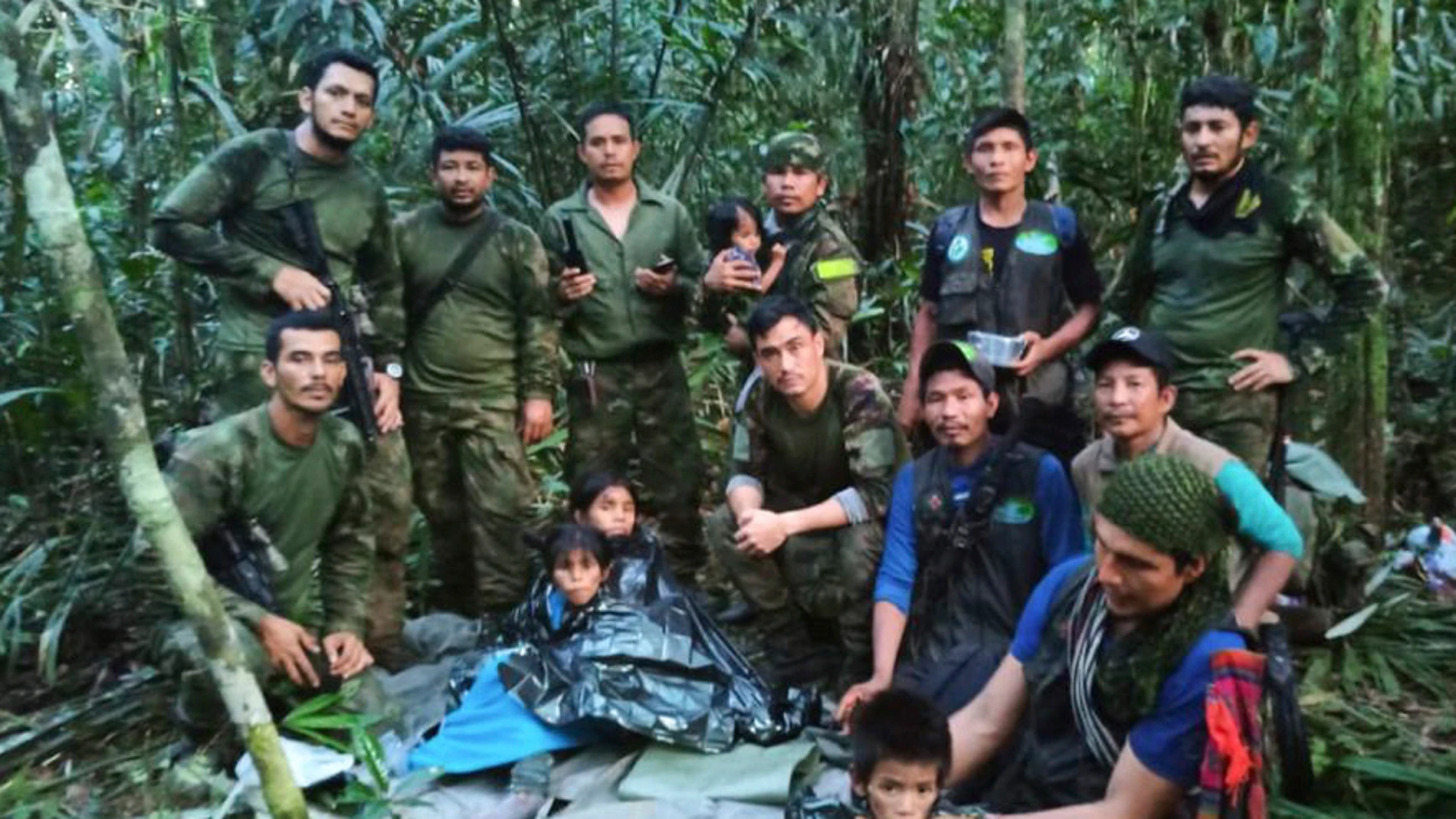 Soldados de las Fuerzas Armadas de Colombia e integrantes del equipo de búsqueda indígena con los cuatro niños