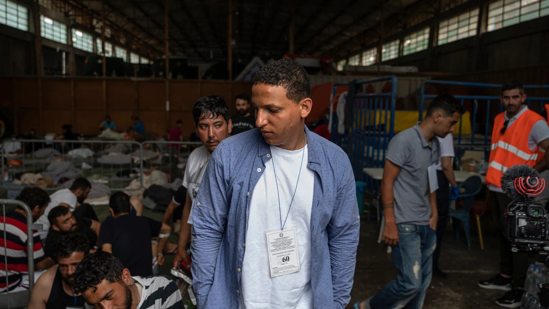 Survivors of a shipwreck are seen inside a warehouse where are taking shelter at the port in Kalamata town, about 240 kilometers (150miles) southwest of Athens, on Thursday, June 15, 2023. A fishing boat crammed to the gunwales with migrants trying to reach Europe capsized and sank Wednesday June 14 off the coast of Greece, authorities said, leaving at least 79 dead and many more missing in one of the worst disasters of its kind this year. (Angelos Tzortzinis, Pool via AP)