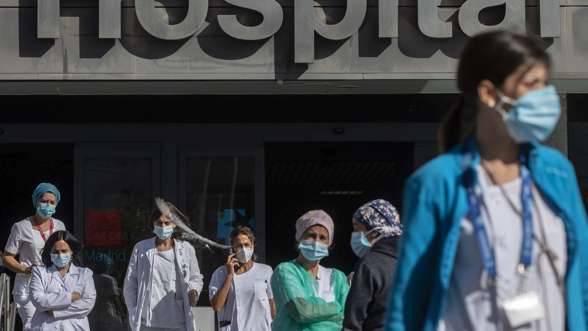 Medical staff and nurses wearing face masks to prevent the spread of coronavirus gather during a protest demanding an improvement in wages and labor conditions at La Paz hospital in Madrid, Spain, Monday, Oct. 5, 2020. Madrid has been the source of Europe's most worrying surge of infections in the ongoing second wave of the pandemic.