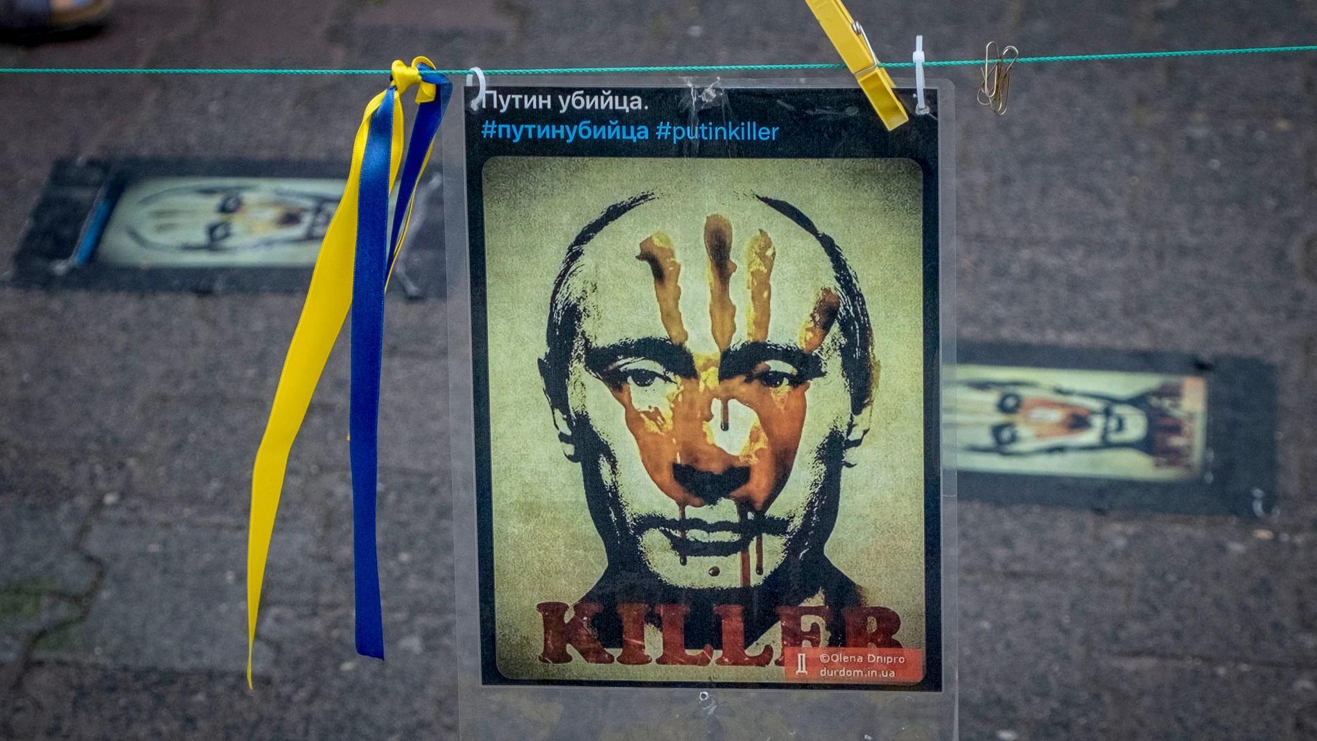 A poster showing Russian President Putin is displayed as part of a vigil near the Russian consulate in Frankfurt, Germany, Saturday, June 24, 2023. (AP Photo/Michael Probst)