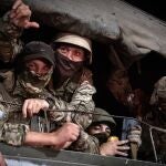 Members of Wagner group looks from a military vehicle in Rostov-on-Don late on June 24, 2023. - Rebel mercenary leader Yevgeny Prigozhin who sent his fighters to topple the military leaders in Moscow will leave for Belarus and a criminal case against him will be dropped as part of a deal to avoid "bloodshed," the Kremlin said on June 24. 