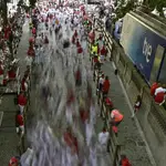 Runners stream into the bullring in this photo taken with a slow camera shutter speed during the running of the bulls at the San Fermin Festival in Pamplona, northern Spain.