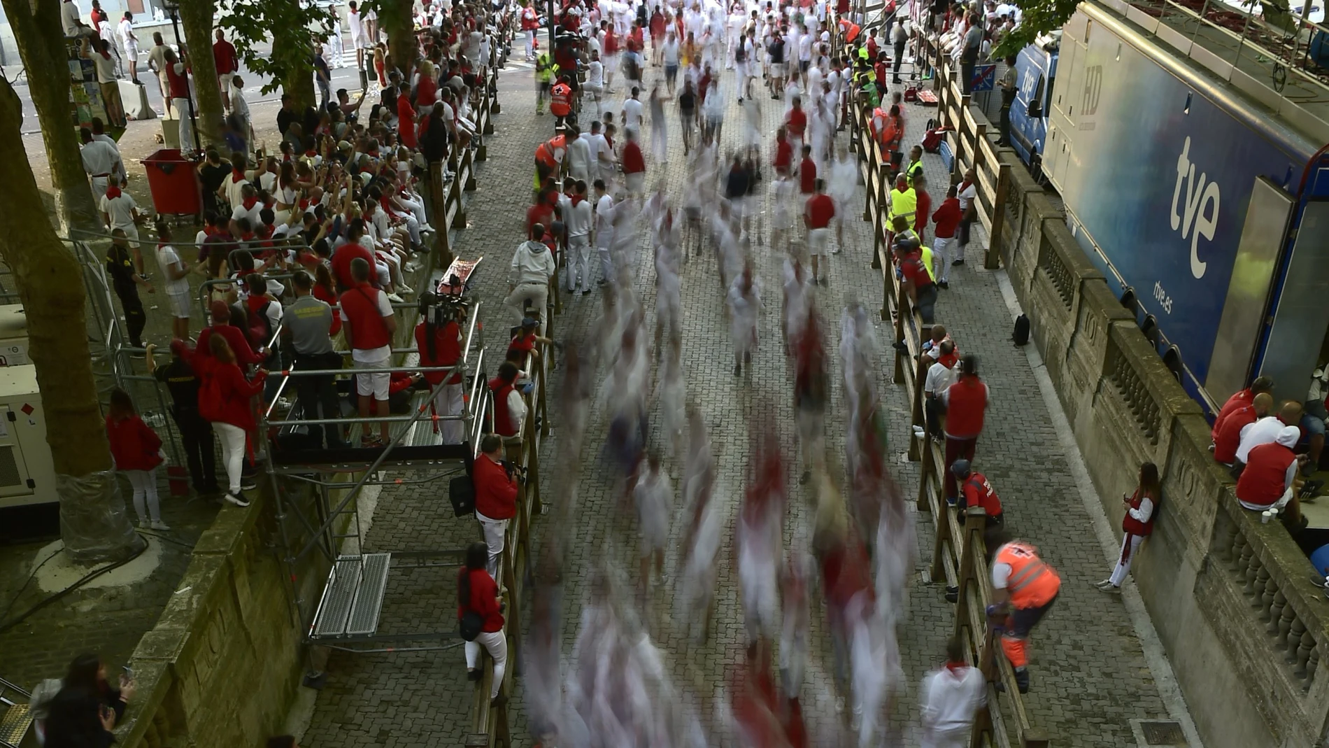Runners stream into the bullring in this photo taken with a slow camera shutter speed during the running of the bulls at the San Fermin Festival in Pamplona, northern Spain.
