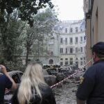 People watch as emergency service workers continue to search for victims after a Russian missile attack in Lviv, Ukraine, Thursday, July 6, 2023. 
