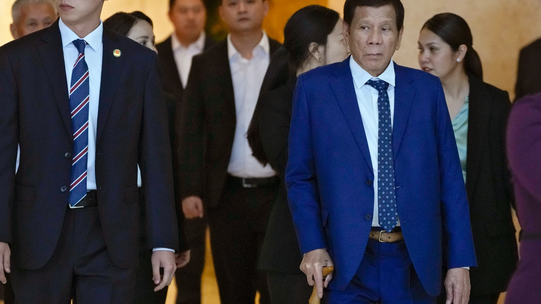 Philippine former President Rodrigo Duterte, right, is escorted by officials as he leaves a hotel in Beijing, Monday, July 17, 2023. Duterte met with Chinese President Xi Jinping, according to CCTV reports. (AP Photo/Andy Wong)