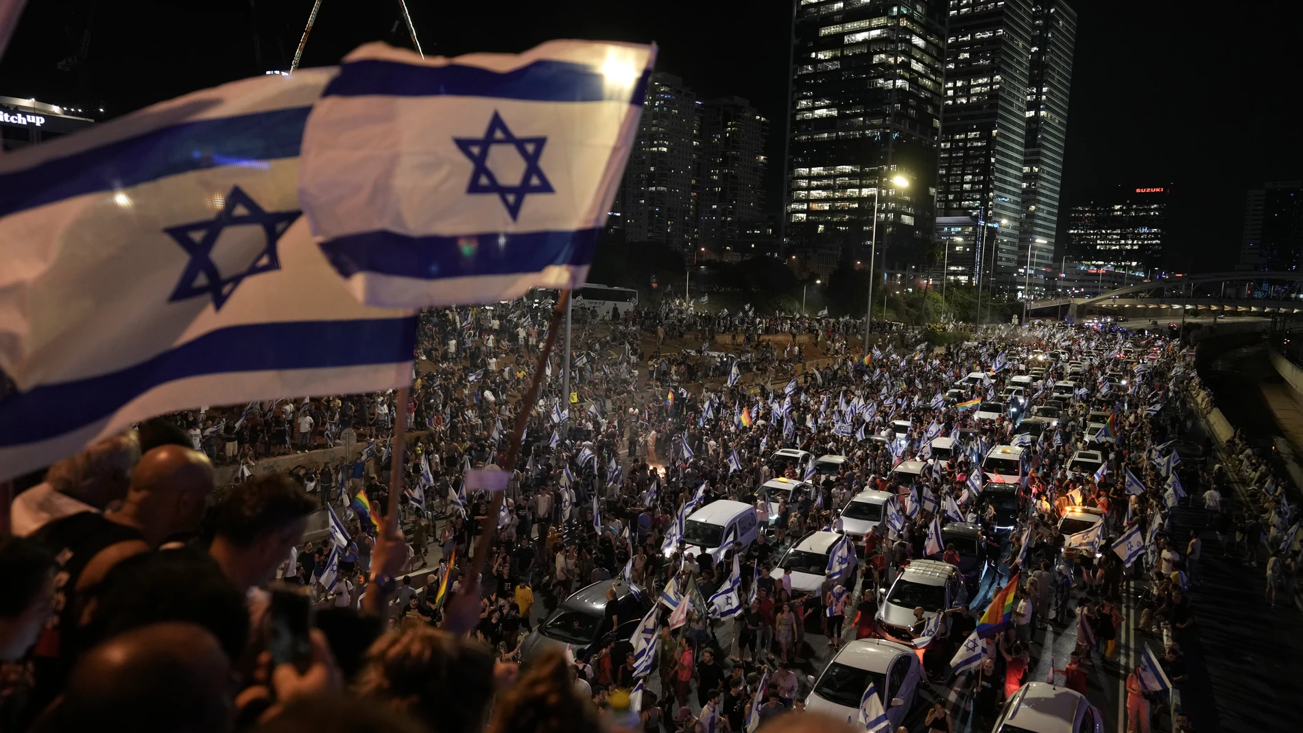 Demonstrators block the traffic on a highway crossing the city during a protest against plans by Netanyahu's government to overhaul the judicial system, in Tel Aviv, Monday, July 24, 2023. Israeli lawmakers on Monday approved a key portion of Prime Minister Benjamin Netanyahu's divisive plan to reshape the country's justice system despite massive protests that have exposed unprecedented fissures in Israeli society. (AP Photo/Oded Balilty)