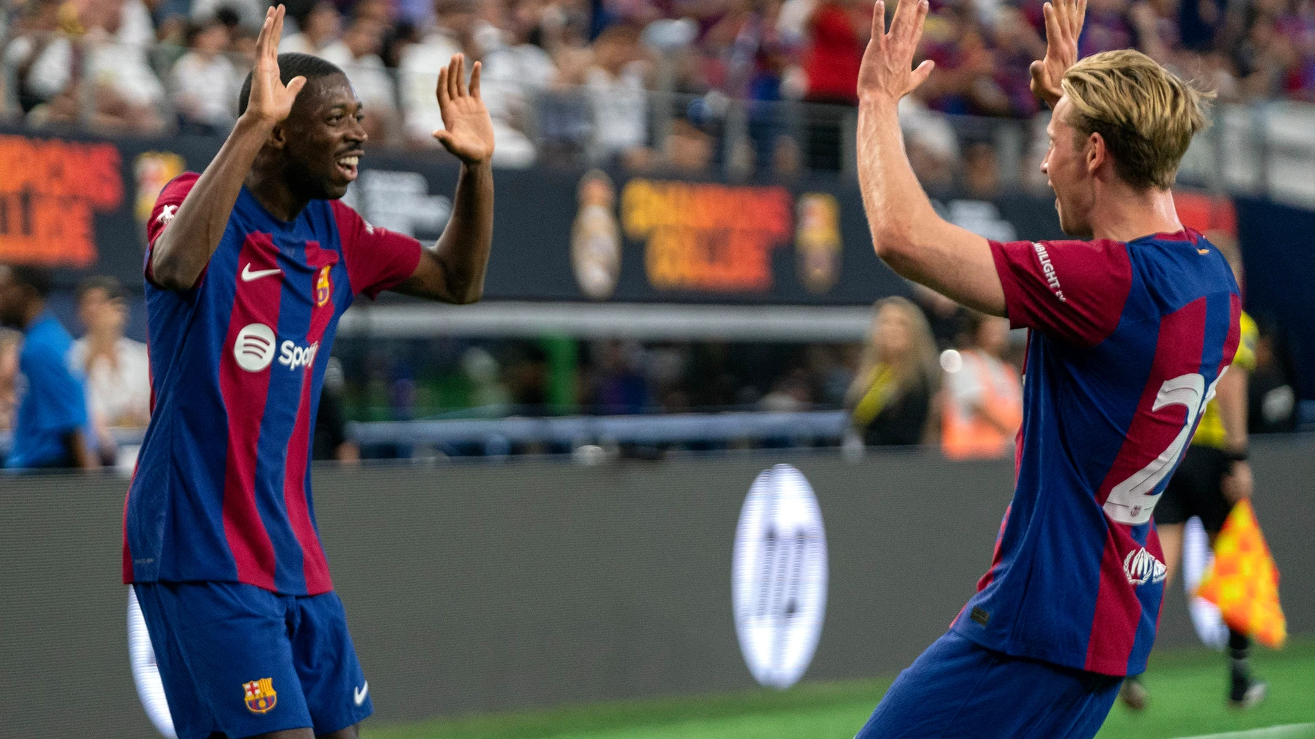FC Barcelona forward Ousmane Dembele, left, celebrates with midfielder Frenkie de Jong (21) after scoring a goal against Real Madrid during the first half of a Champions Tour soccer match, Saturday, July 29, 2023 at AT&T Stadium in Arlington, Texas. (AP Photo/Jeffrey McWhorter)