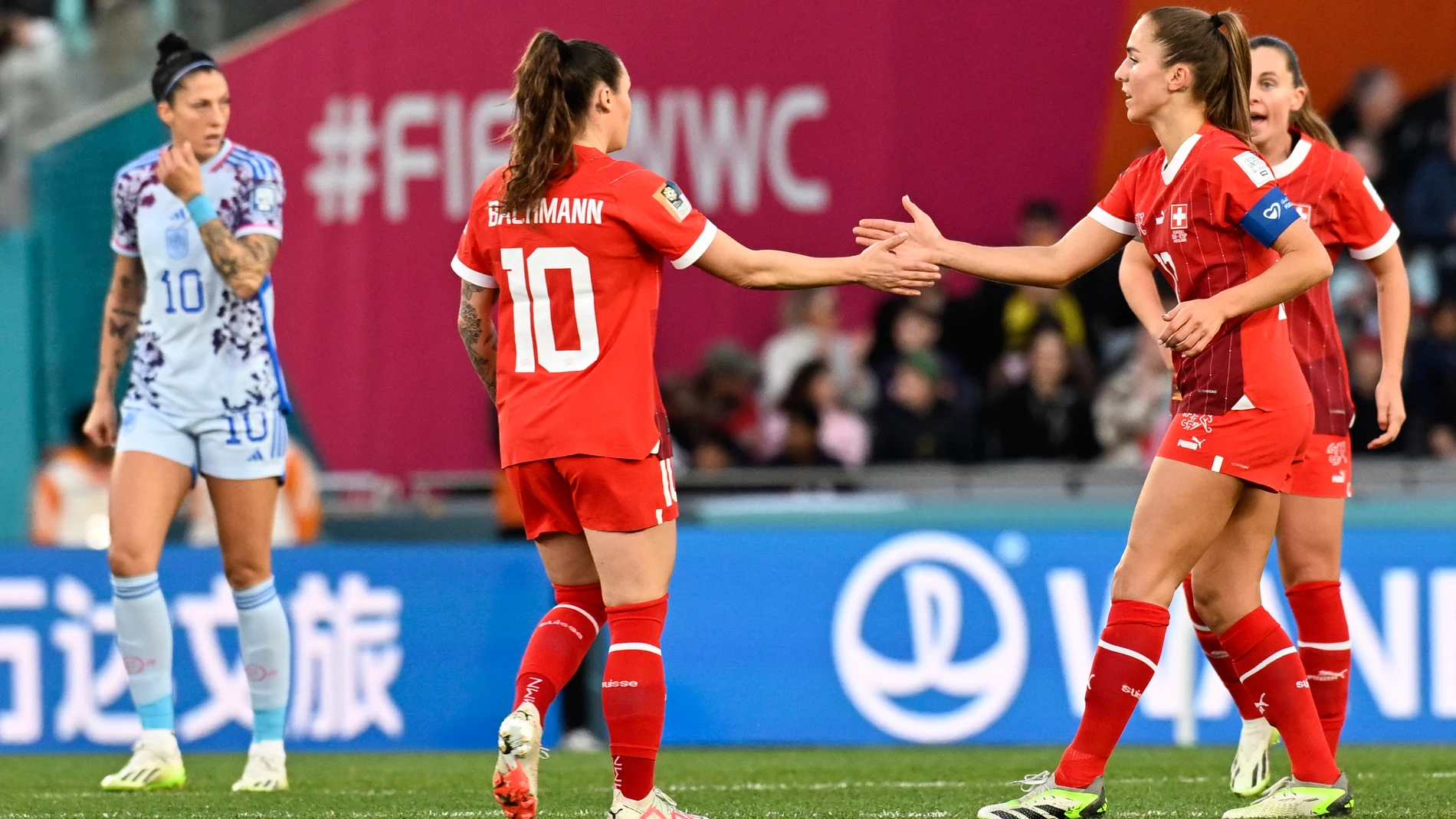 Switzerland's Ramona Bachmann gestures to teammate Lia Waelti, right, following an own goal by Spain's Laia Codina during the Women's World Cup second round soccer match between Switzerland and Spain at Eden Park in Auckland, New Zealand, Saturday, Aug. 5, 2023. (AP Photo/Andrew Cornaga)