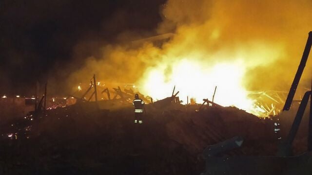 A handout picture made available by the Khmelnytskyi Regional Military Administration shows Ukrainian rescuers putting out a fire at a corn waste warehouse after shelling near Starokostiantyniv, Khmelnytskyi region, western Ukraine, 06 August 2023
