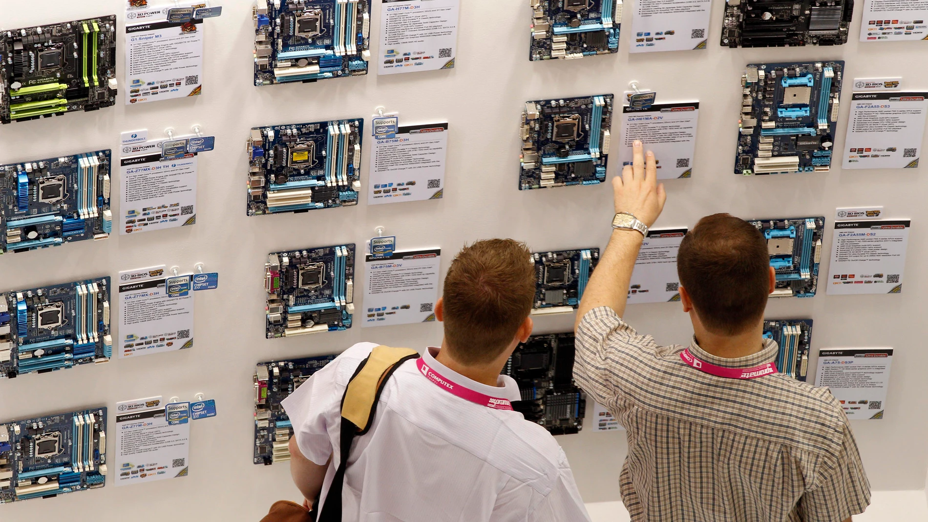 Visitors browse through the new line of GIGABYTE chipsets on the opening day of the Computex exhibition at the Taipei World Trade Center in Taipei, Taiwan.