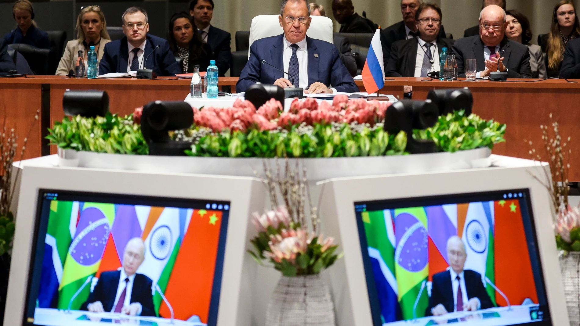 In this photo released by Russian Foreign Ministry Press Service, Russia's Foreign Minister Sergei Lavrov, centre, looks on at the plenary session as Russian President Vladimir Putin delivers his remarks via video link, at the 2023 BRICS Summit in Johannesburg, South Africa, Wednesday, Aug. 23, 2023. (Russian Foreign Ministry Press Service via AP)
