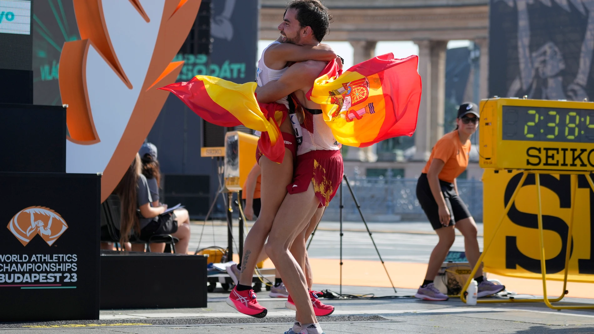 Alvaro Martin, of Spain, right, embraces his compatriot María Perez after winning the men's and women's 35-kilometer race walk during the World Athletics Championships in Budapest, Hungary, Thursday, Aug. 24, 2023. (AP Photo/Ashley Landis)