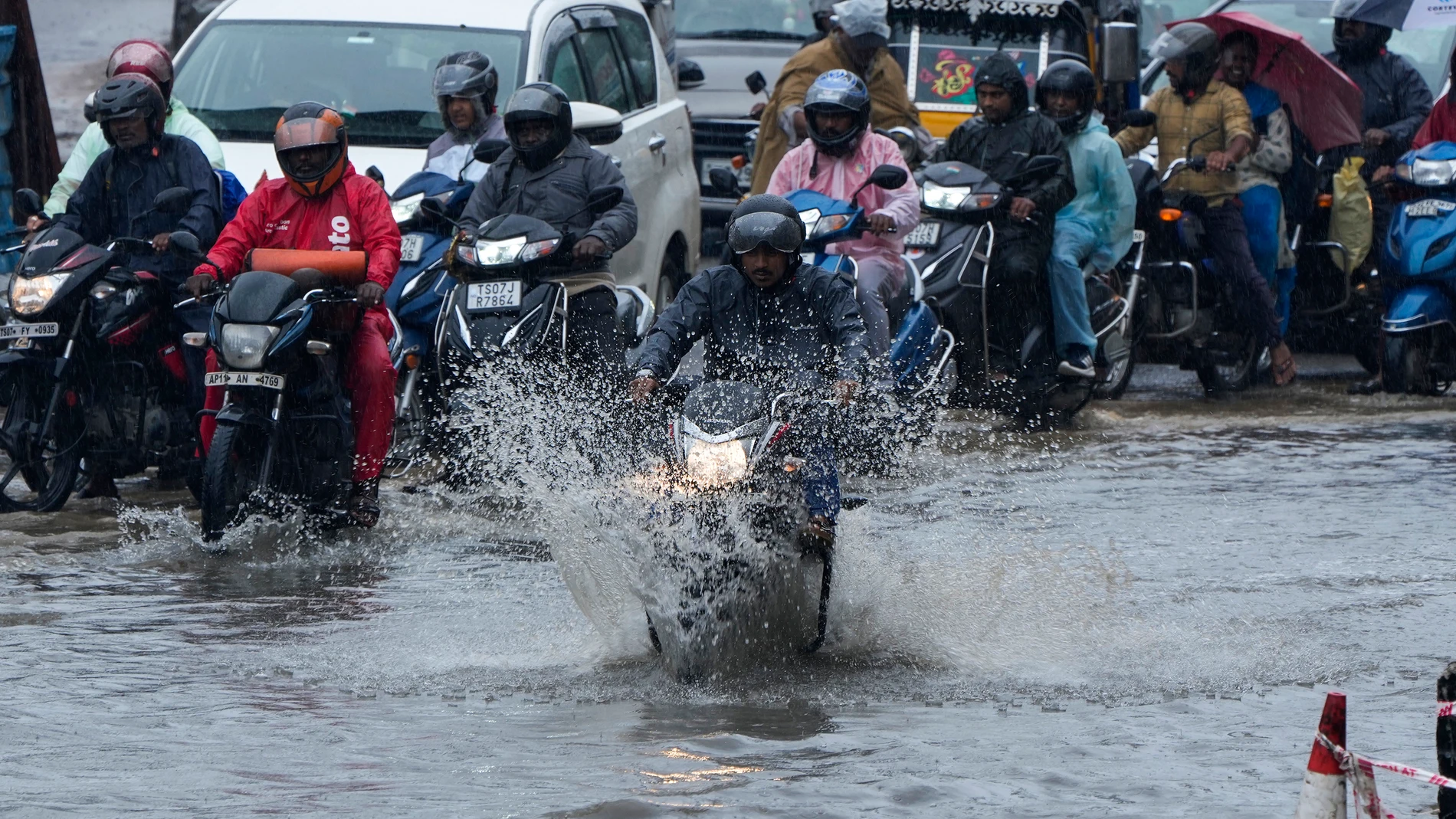 Motorists ride through a water logged street during rain in Hyderabad, India, Tuesday, Sept. 5, 2023. The monsoon season in India lasts from June to September. (AP Photo/Mahesh Kumar A.)