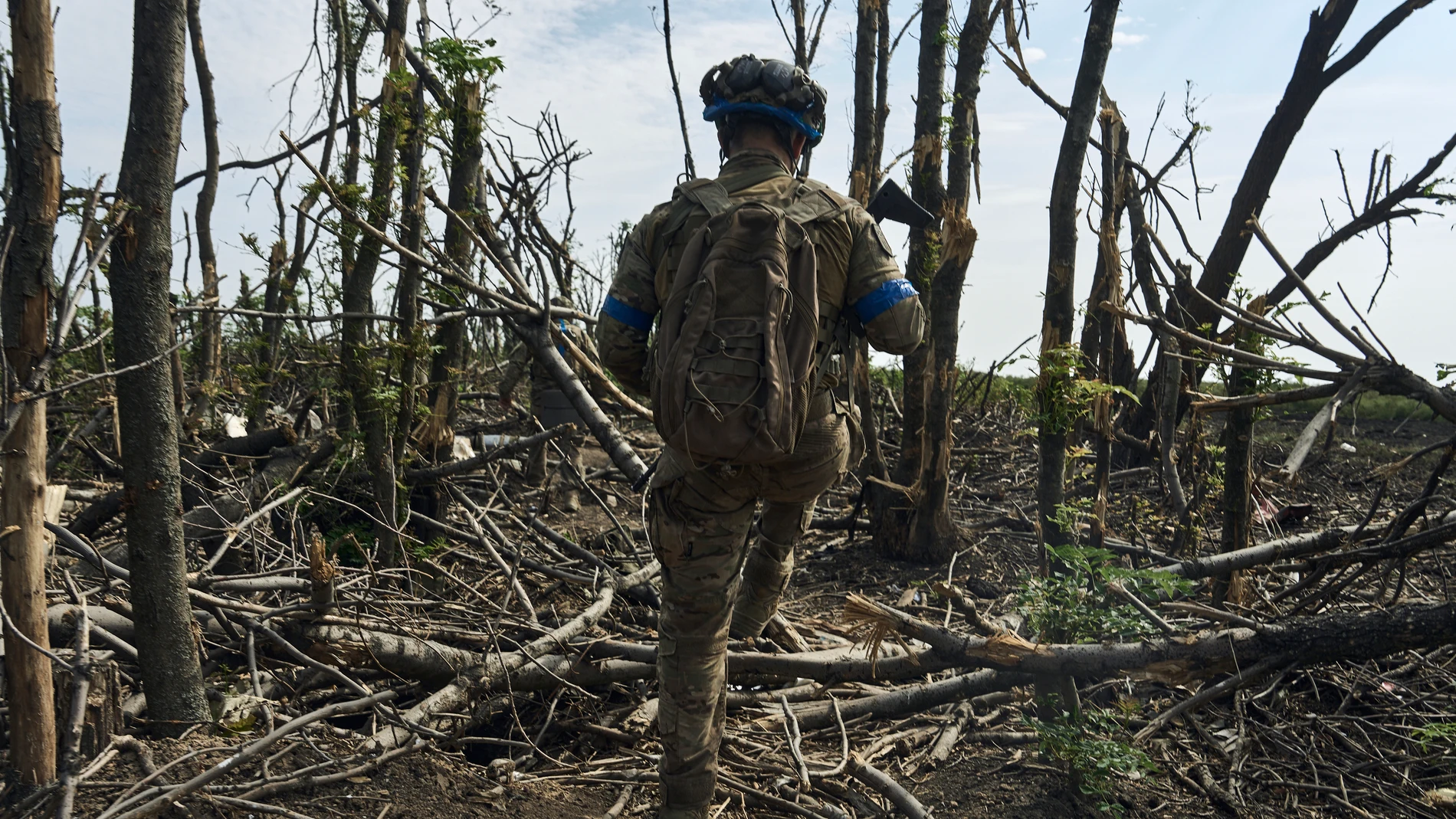 A soldier of Ukraine's 3rd Separate Assault Brigade goes on his position near Bakhmut, the site of fierce battles with the Russian forces in the Donetsk region, Ukraine, Monday, Sept. 4, 2023. (AP Photo/Libkos)