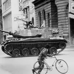 In this Sept. 11, 1973 file photo, a boy pushes a bicycle across a deserted street as an army tank moves towards La Moneda presidential palace during a coup against President Salvador Allende&#39;s government, after which Gen. Augusto Pinochet seized power, in Santiago, Chile. On Sept. 11, 2013, Chile marks the 40th anniversary of the coup.