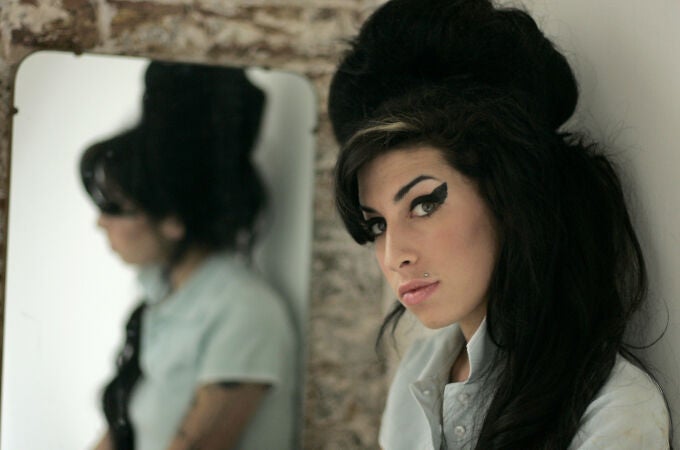 In this Feb. 16, 2007 file photo, British singer Amy Winehouse poses for photographs after being interviewed by The Associated Press at a studio in north London.