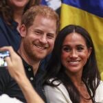 Britain's Prince Harry (C), Duke of Sussex, and his wife Meghan, Duchess of Sussex smile for a picture during a Wheelchair Basketball game at the 6th Invictus Games in Duesseldorf, Germany,