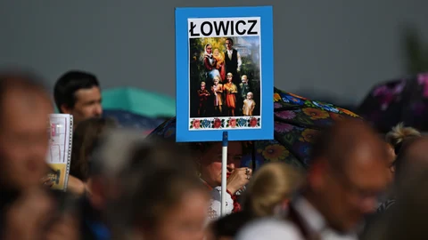 A depiction of the the Ulma family is shown as people attend the service to beatify Jozef and Wiktoria Ulma and their seven children, who were murdered in 1944 by German Nazis for sheltering Jews, in Markowa, where the Ulma family once lived, in southeastern Poland