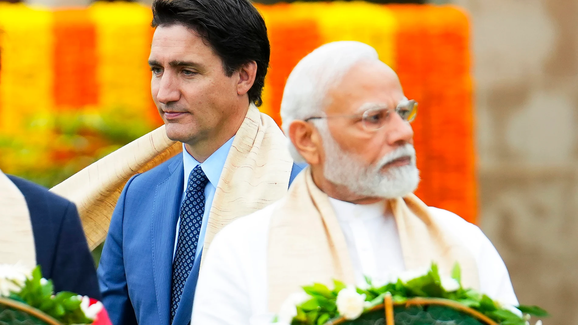 FILE - Canada's Prime Minister Justin Trudeau, left, walks past Indian Prime Minister Narendra Modi as they take part in a wreath-laying ceremony at Raj Ghat, Mahatma Gandhi's cremation site, during the G20 Summit in New Delhi, Sunday, Sept. 10, 2023. Trudeau said that Canada wasn't looking to escalate tensions, but asked India on Tuesday, Sept. 19, to take the killing of a Sikh activist seriously after India called accusations that the Indian government may have been involved absurd.(Sean Ki...